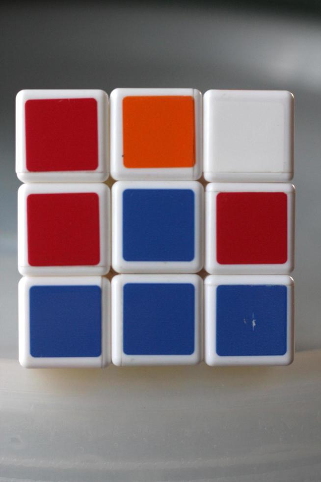Rubik's cube on the black background. Rubik's Cube was invented by Hungarian architect Erno Rubik in 1974. photo