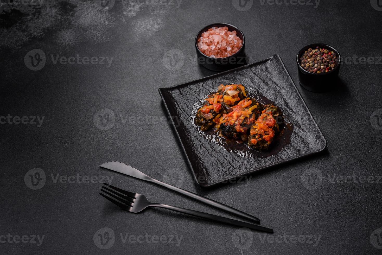 Dolma, stuffed grape leaves with rice and meat on a dark background photo