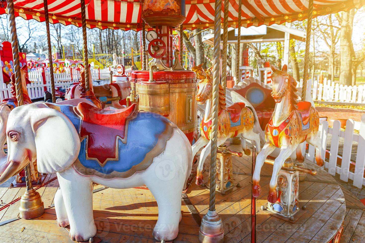 Vintage Merry-Go-Round flying horse carousel in amusement holliday park photo