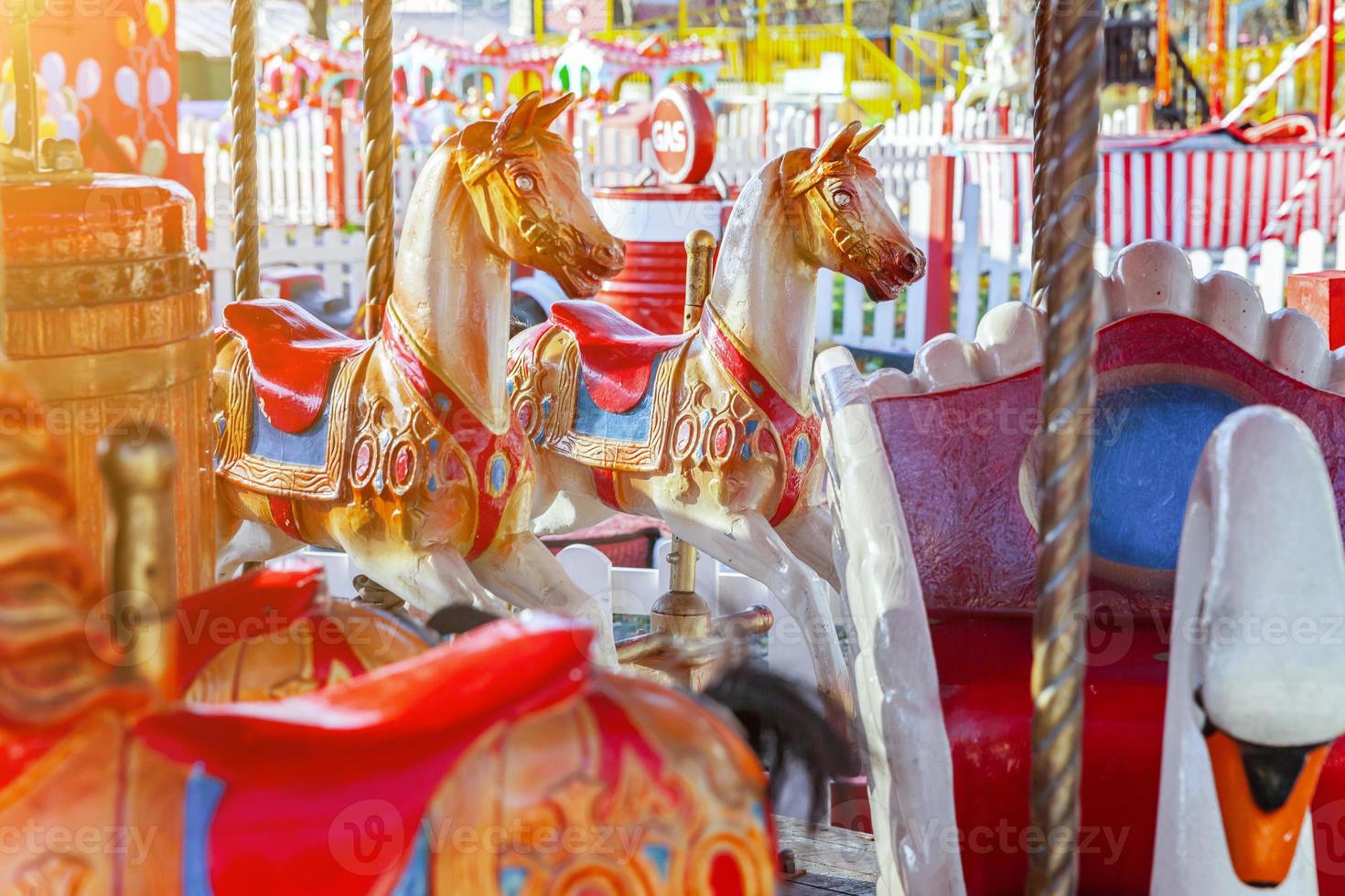 Vintage Merry-Go-Round flying horse carousel in amusement holliday park photo