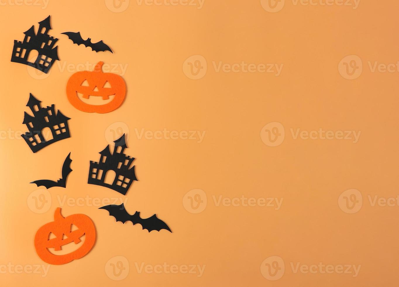 decorations for Halloween holiday, Halloween pumpkins, castles and bats on orange background. photo