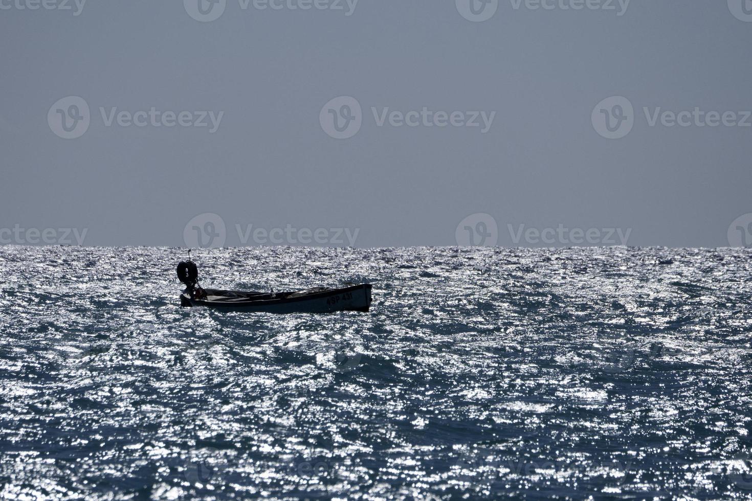 small boat in high waves sea photo