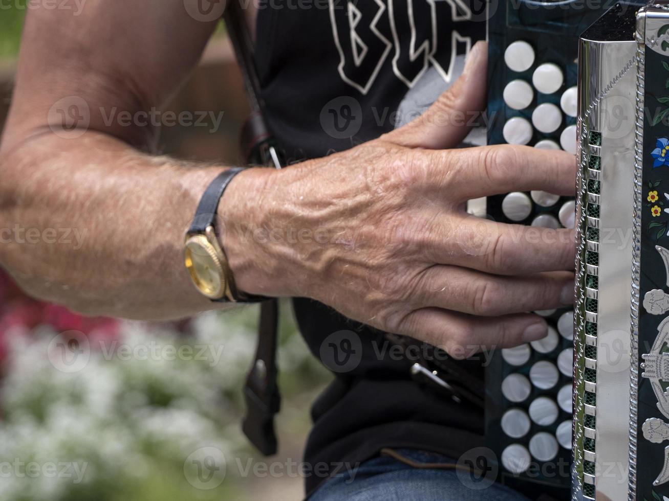 Hands playing accordion detail photo