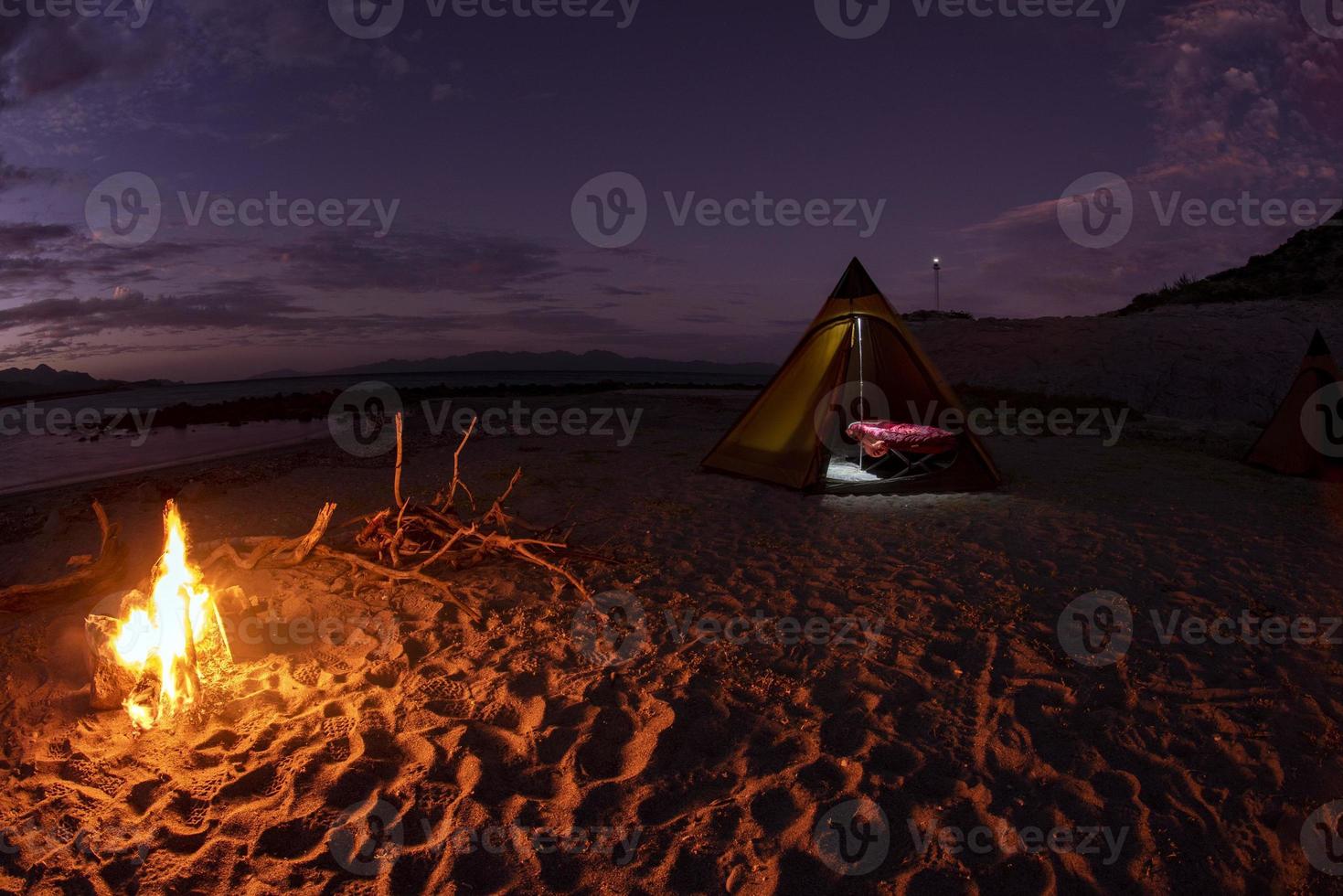 tent camp in desert sandy beach in california at night photo