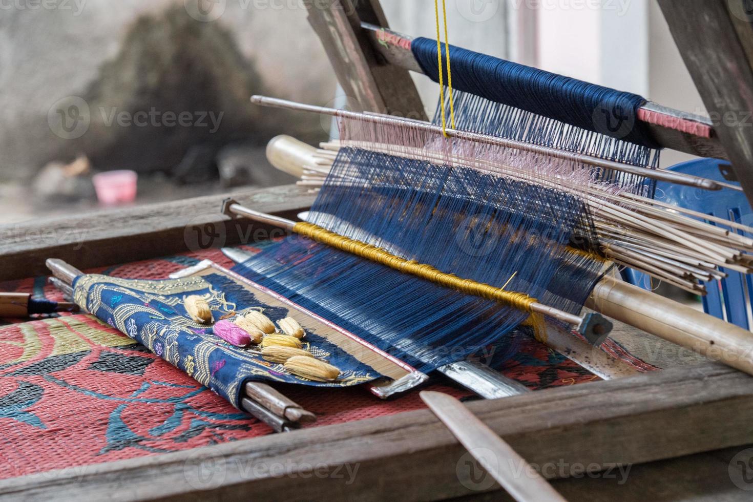 woman hand working at loom close up photo