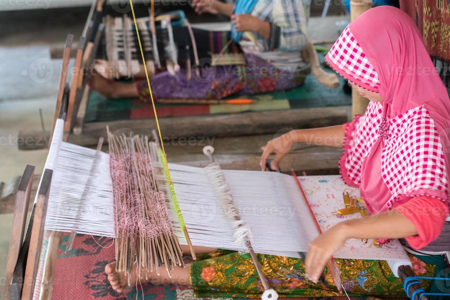 woman hand working at loom close up photo