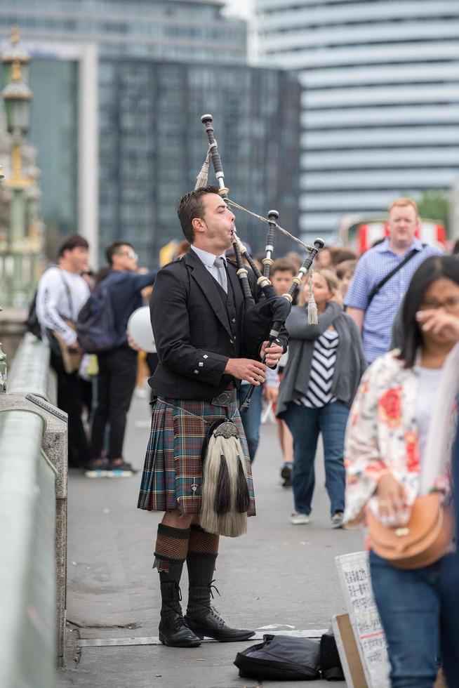 LONDON, ENGLAND - JULY 15 2017 - Man playing cornamuse on London Bridge photo