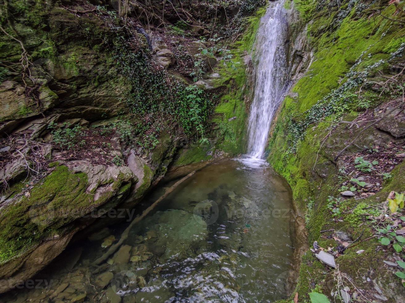 Small waterfall with green moss photo