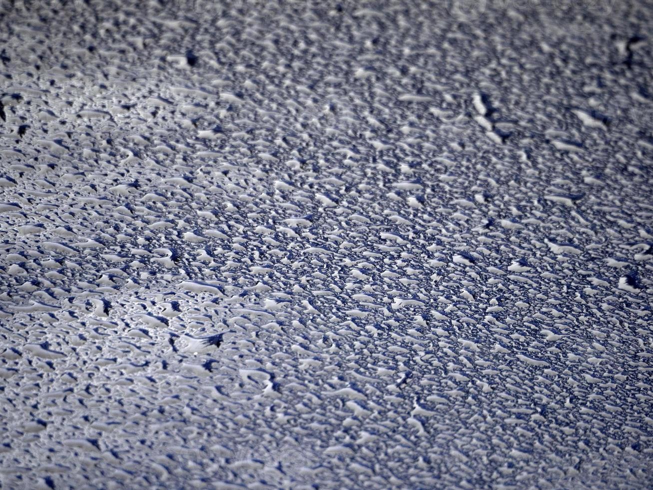 rain drops on blue metal close up macro photo