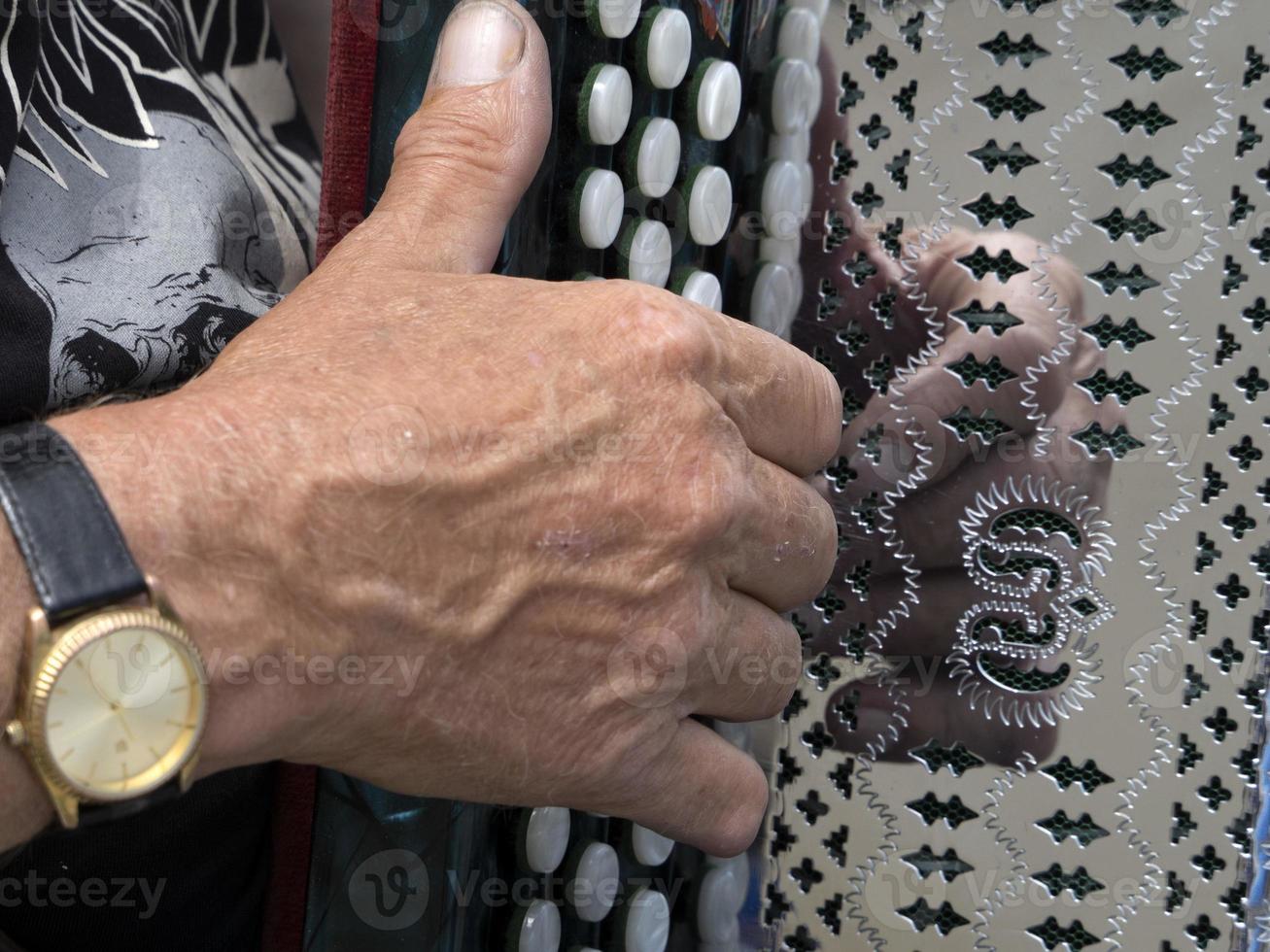 Hands playing accordion detail photo