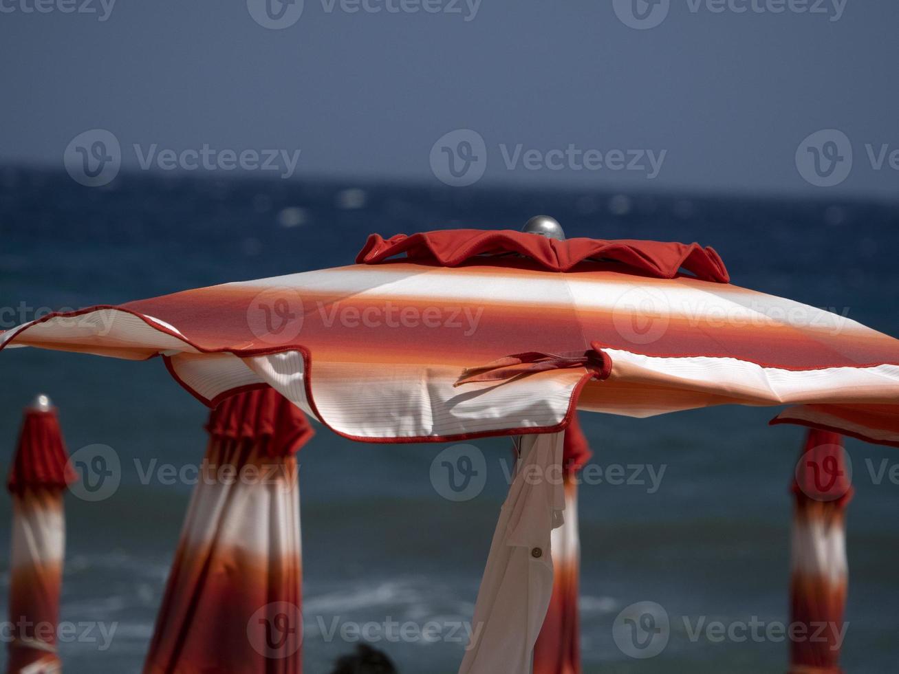 summer sun umbrellas on liguria beach photo