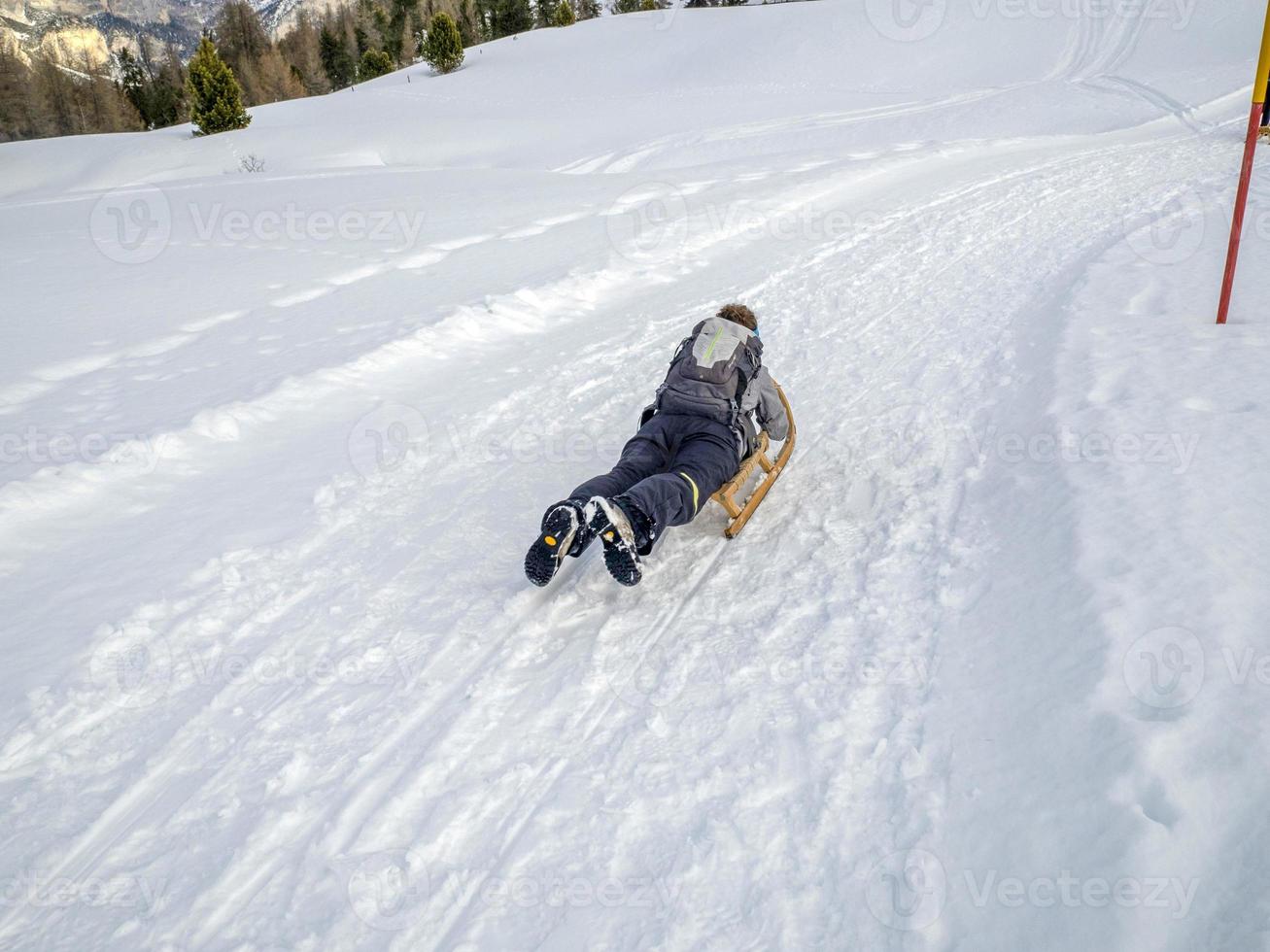 wooden sledge on the snow in dolomites photo