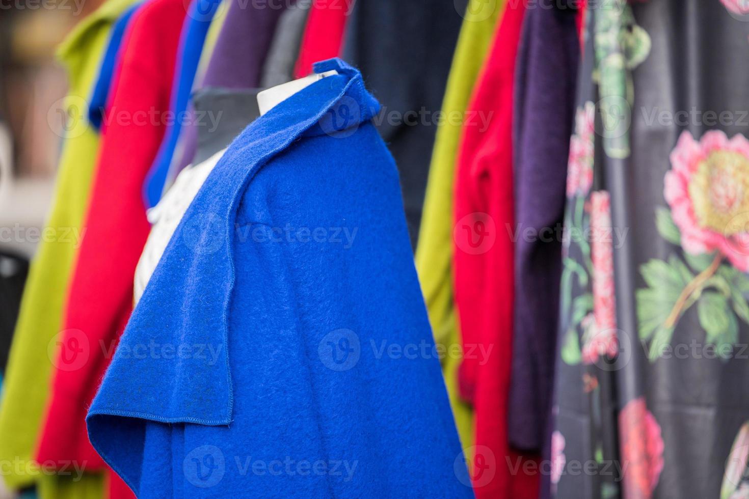 Vintage clothes for sale inside a shop photo