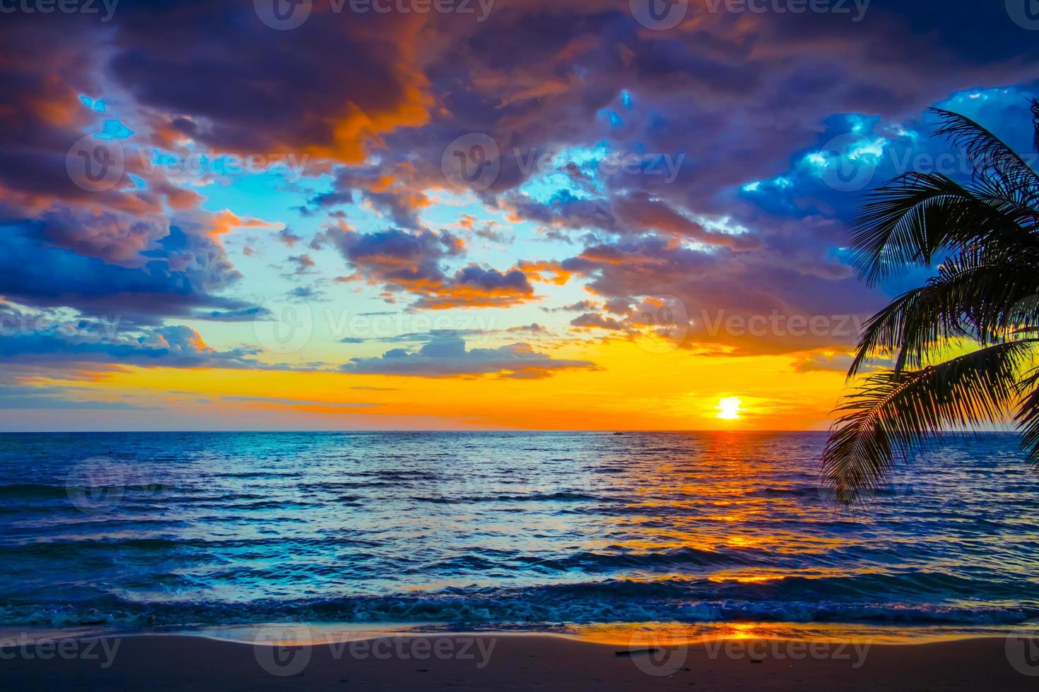 Silhouette of palm trees Beautiful sunset on the tropical sea beach background for travel in holiday relax time, photo