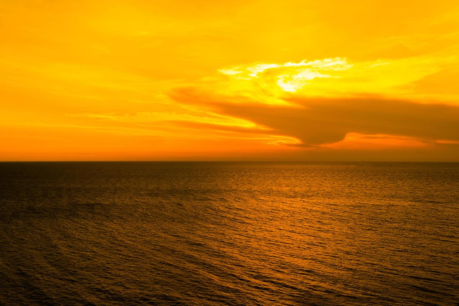 Beautiful sunset in the sea with Twilight sky on orange color background photo