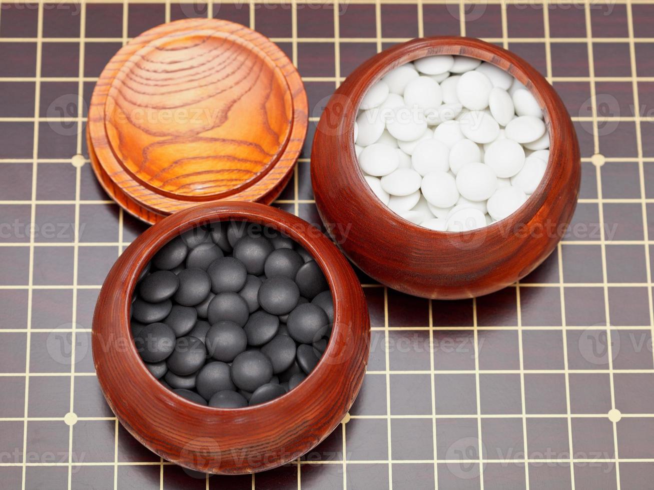 go game stones in wooden bowls photo