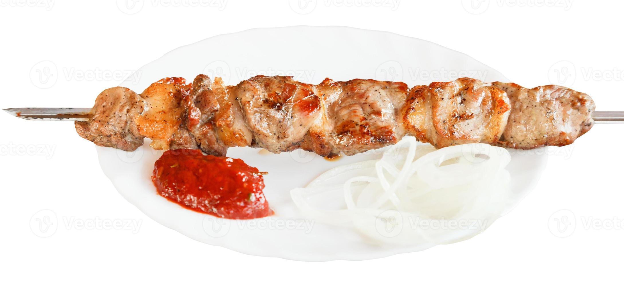 one lamb shish kebab on white plate isolated photo