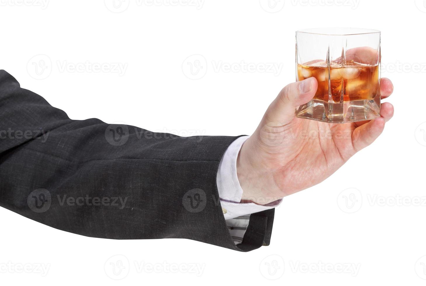 side view of whisky glass in businessman hand photo