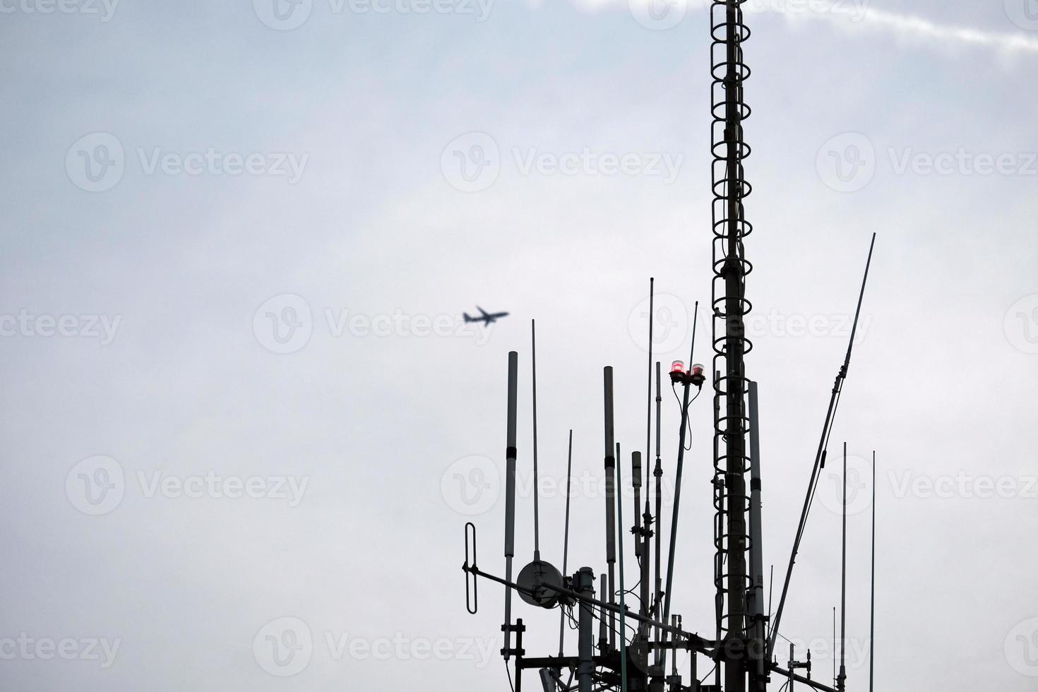 Telecommunication antenna against the evening sky photo