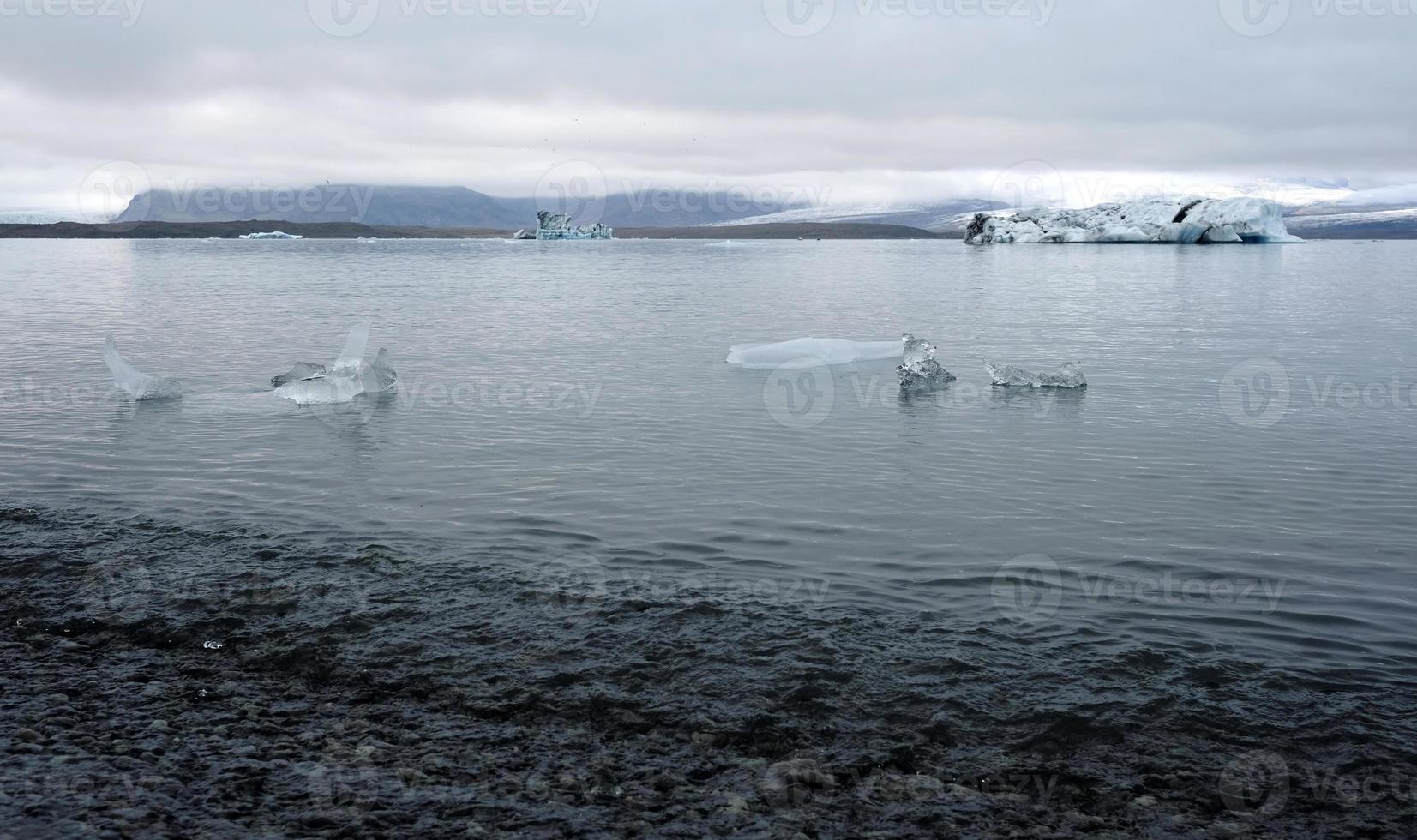 Jokulsarlon Glacier Lagoon in Iceland with icebergs and clear water photo