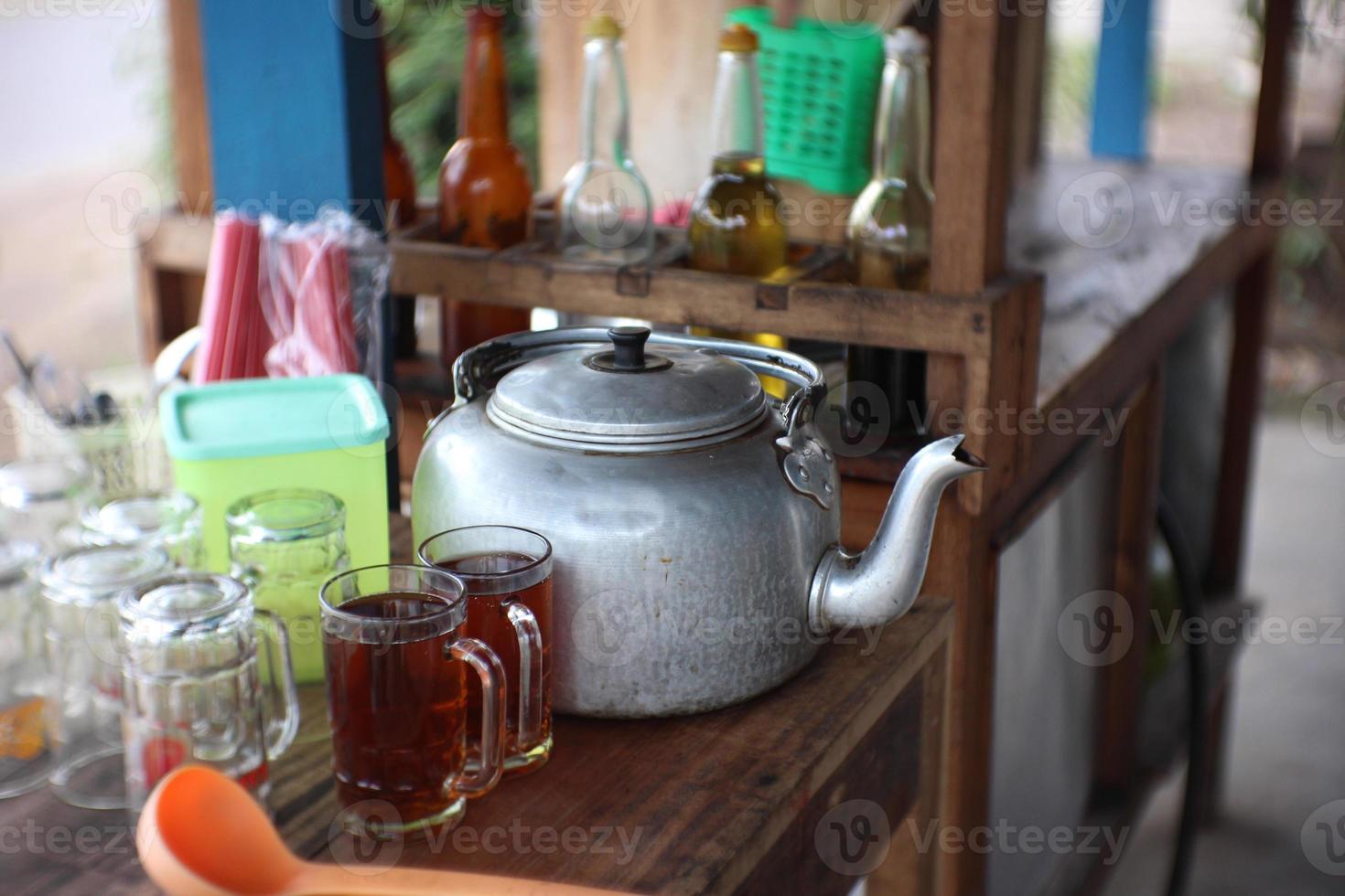 two glasses of sweet tea on a wooden table photo
