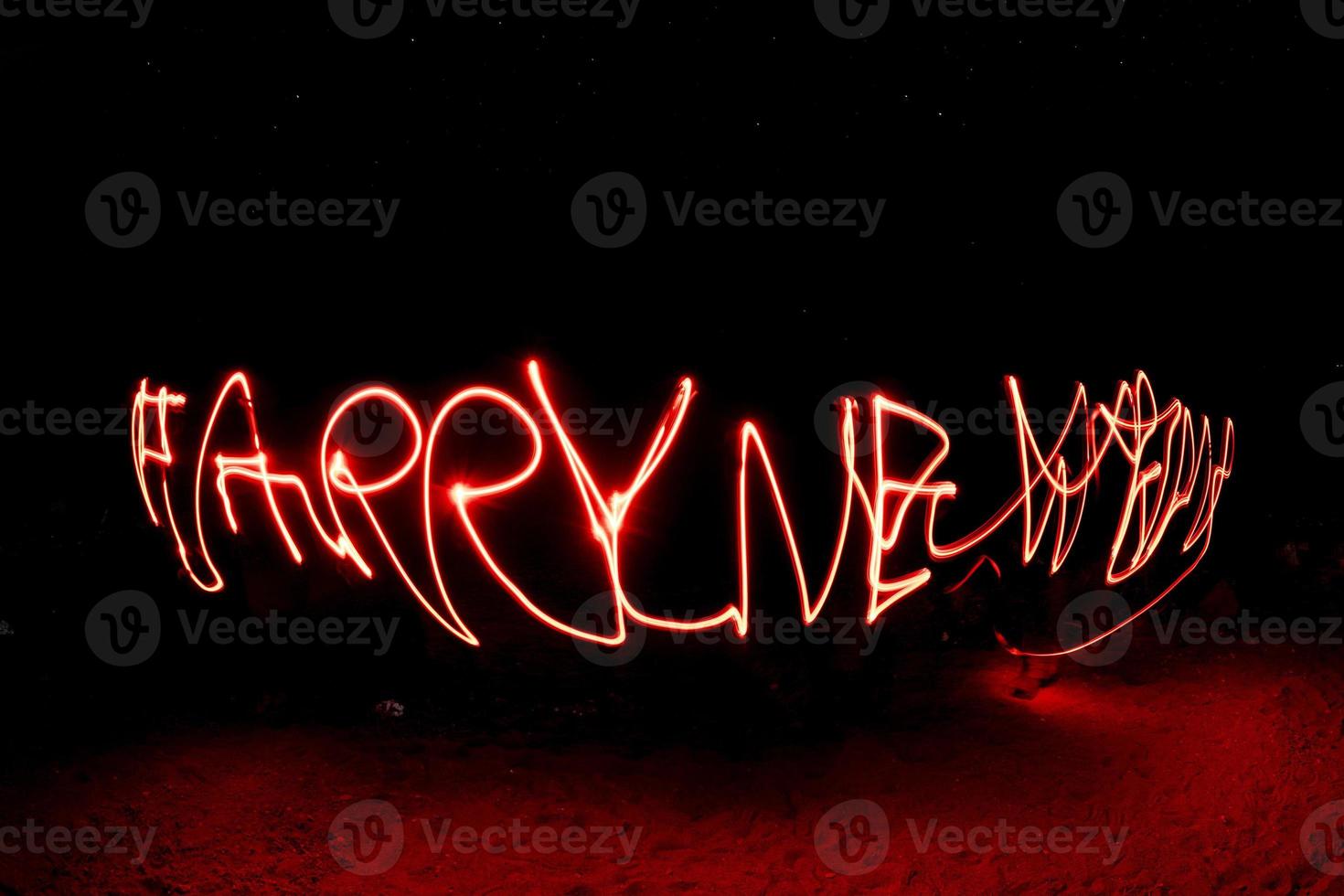 happy new year light painting on black photo