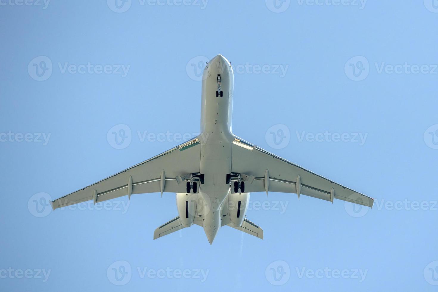 airplane jet while landing from bottom photo