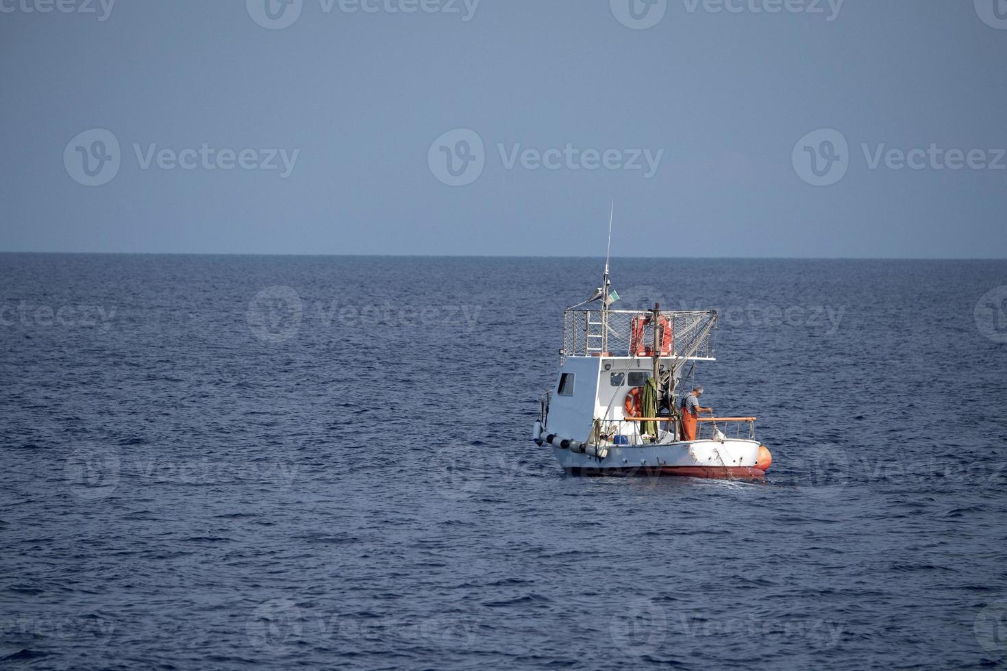 small fishing boat in mediterranean sea photo