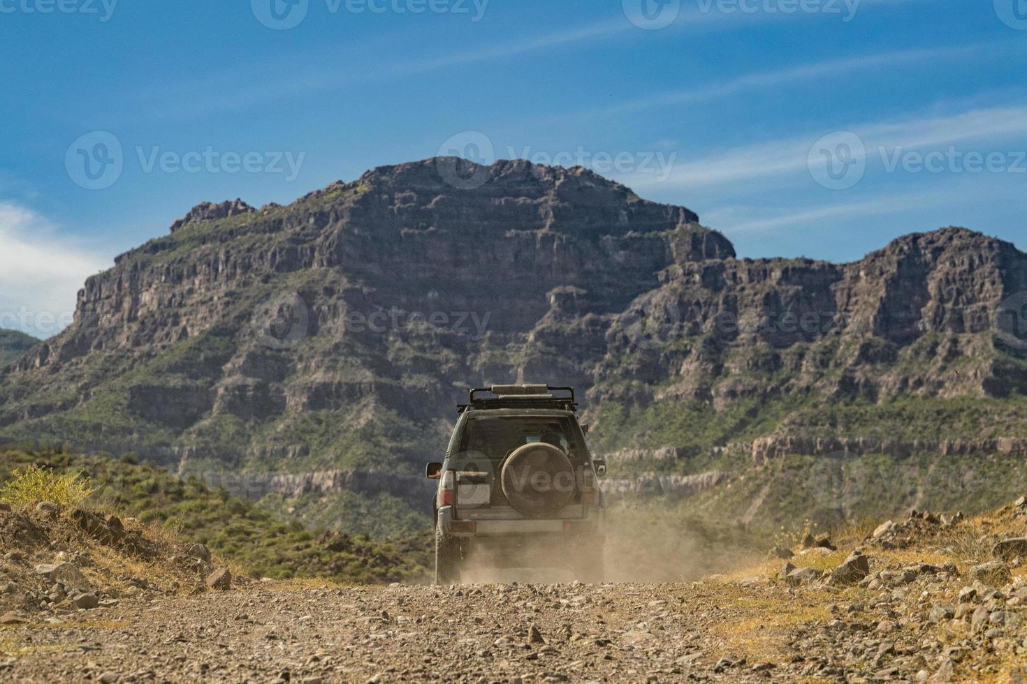 Car in baja california landscape panorama desert road with cortez sea on background photo