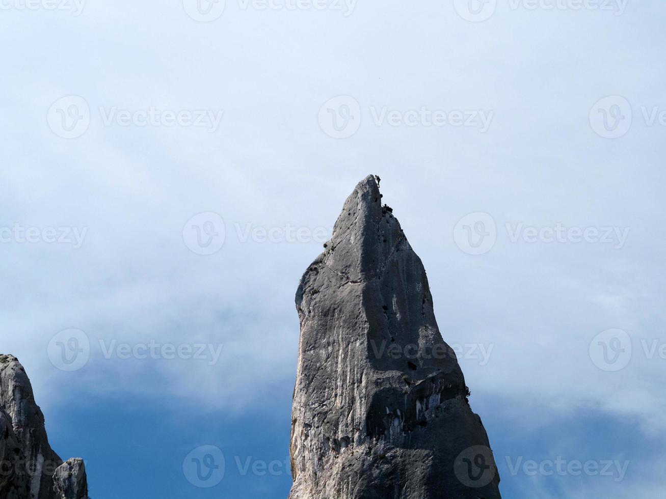 climber on Goloritze rock cliff by the sea Sardinia Italy photo