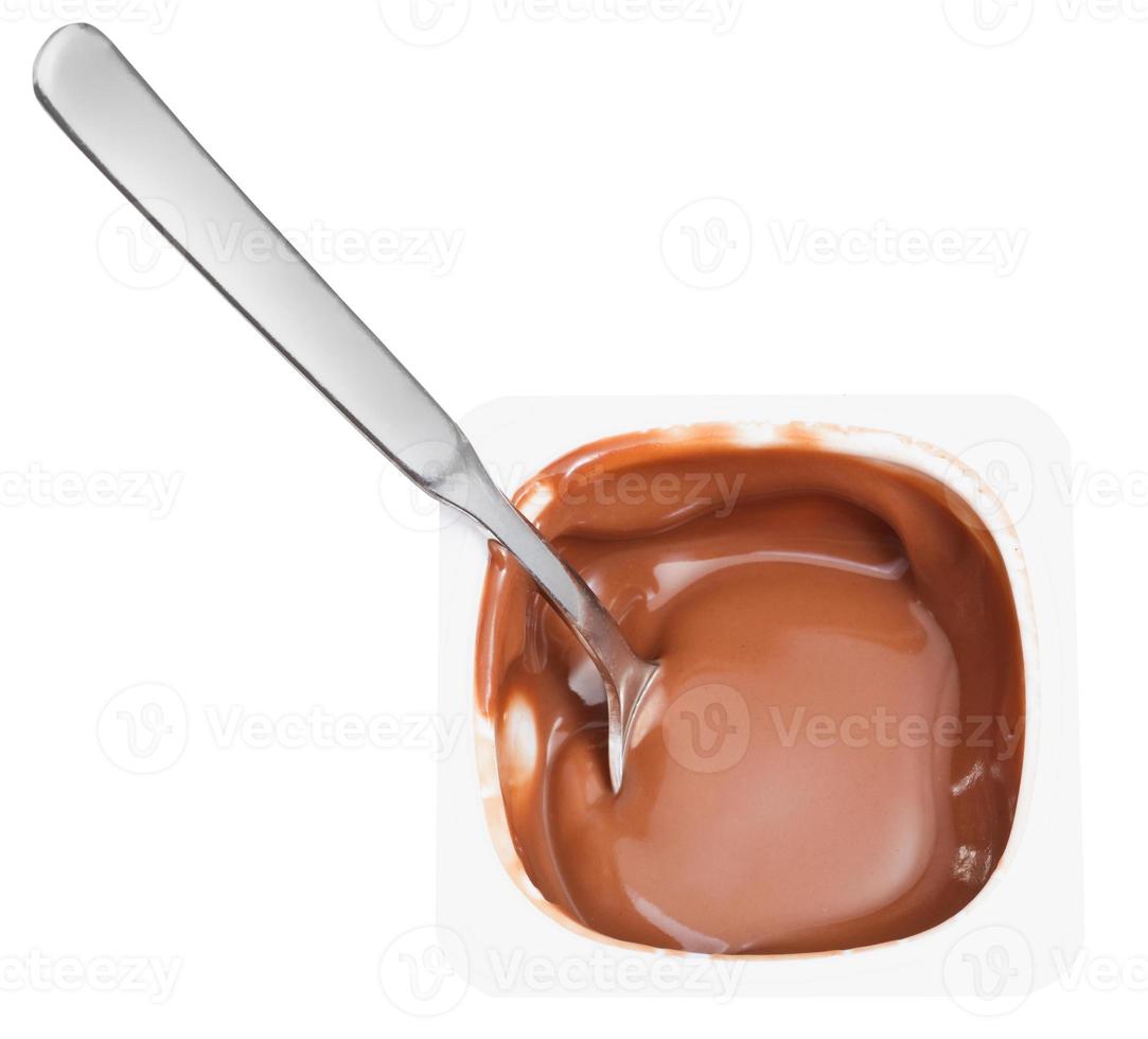 chocolate yogurt and spoon in plastic cup photo