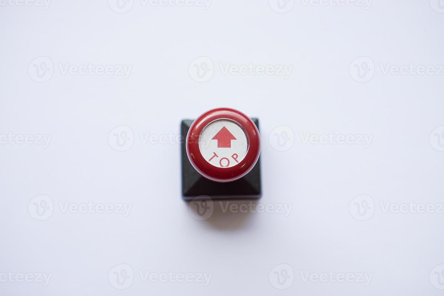 stamp with red handle, arrow and top words photo