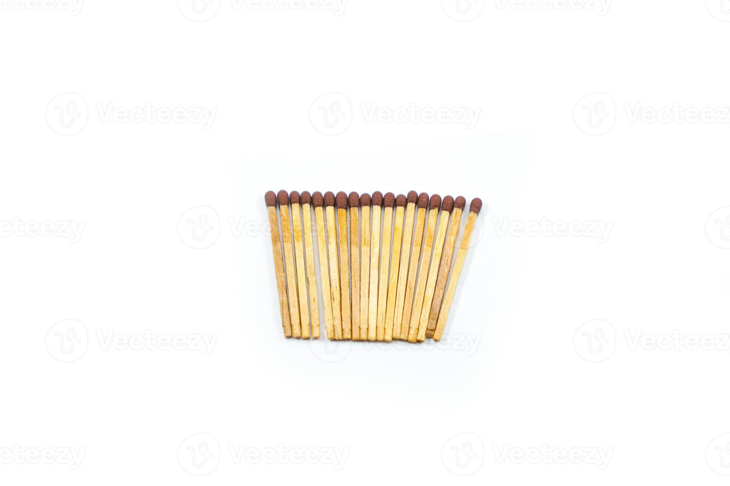 a collection of matchsticks neatly arranged isolated on a white photo