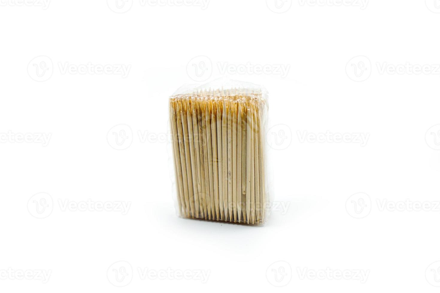 toothpick made of wood wrapped in plastic isolated on a white photo