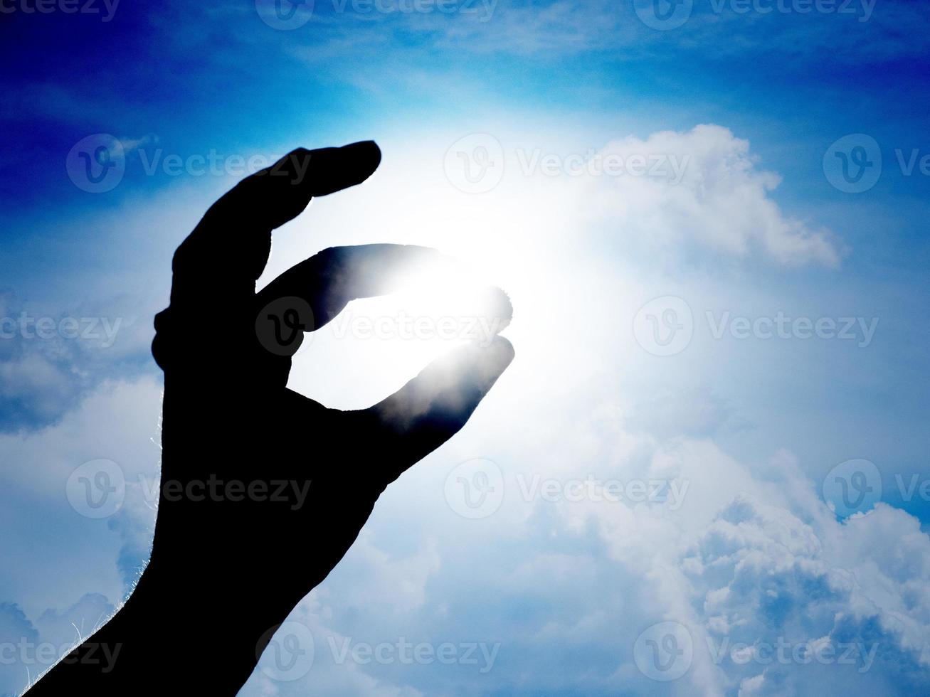 hand catching the sun photo