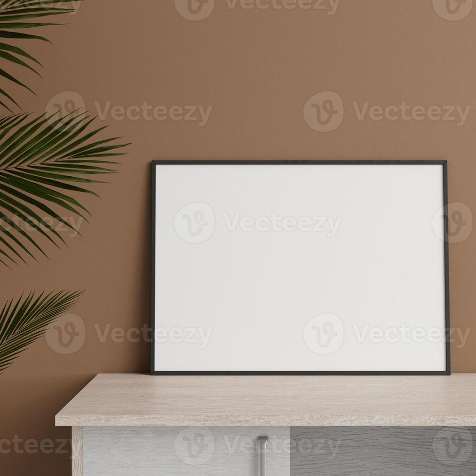 Minimalist front view horizontal black photo or poster frame mockup leaning against wall on table with plant. 3d rendering.