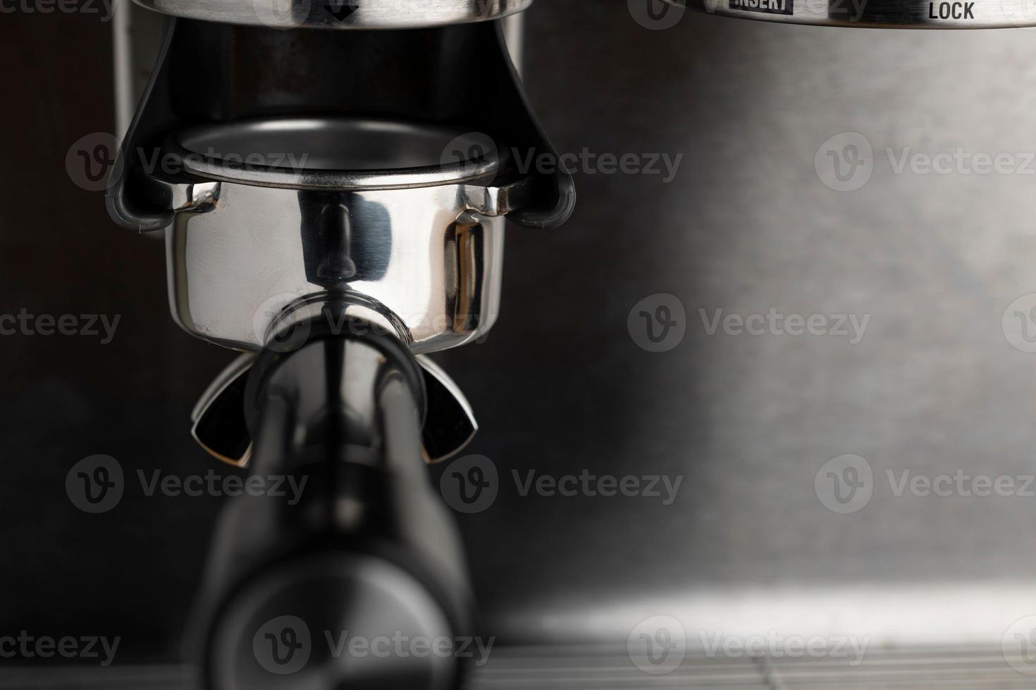 A closeup shot of an espresso coffee machine photo