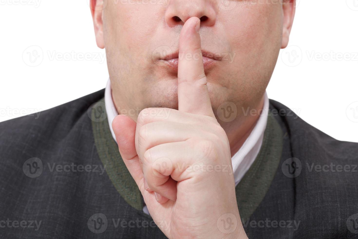 male finger near lips - silence hand gesture photo