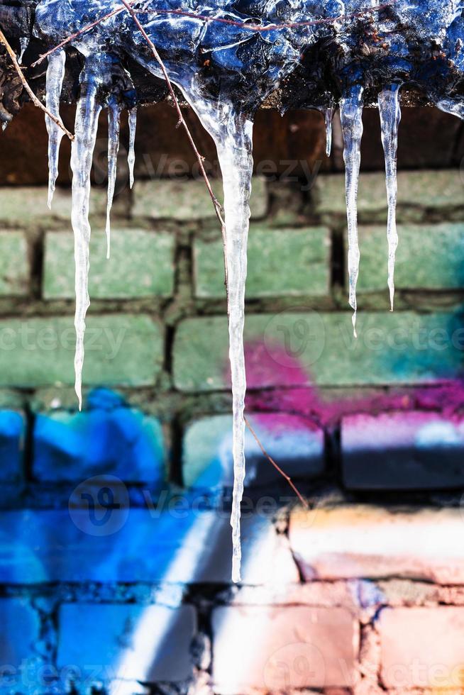 icicles on roof of building with painted wall photo