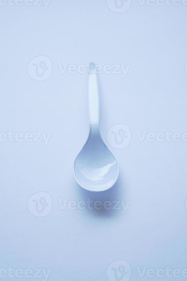 White disposable plastic spoon used for eating photo