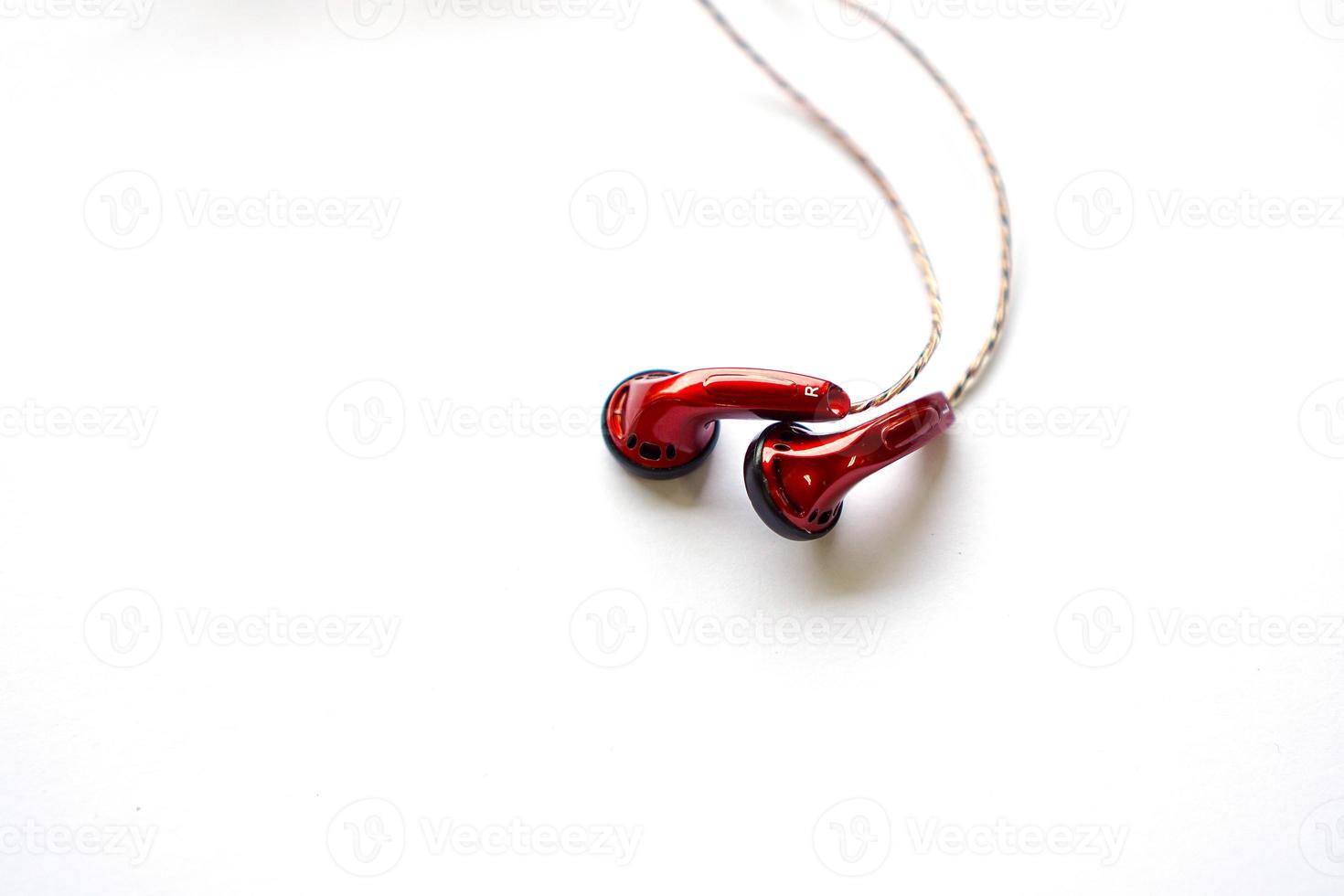 red earphones using wires isolated on white. photo