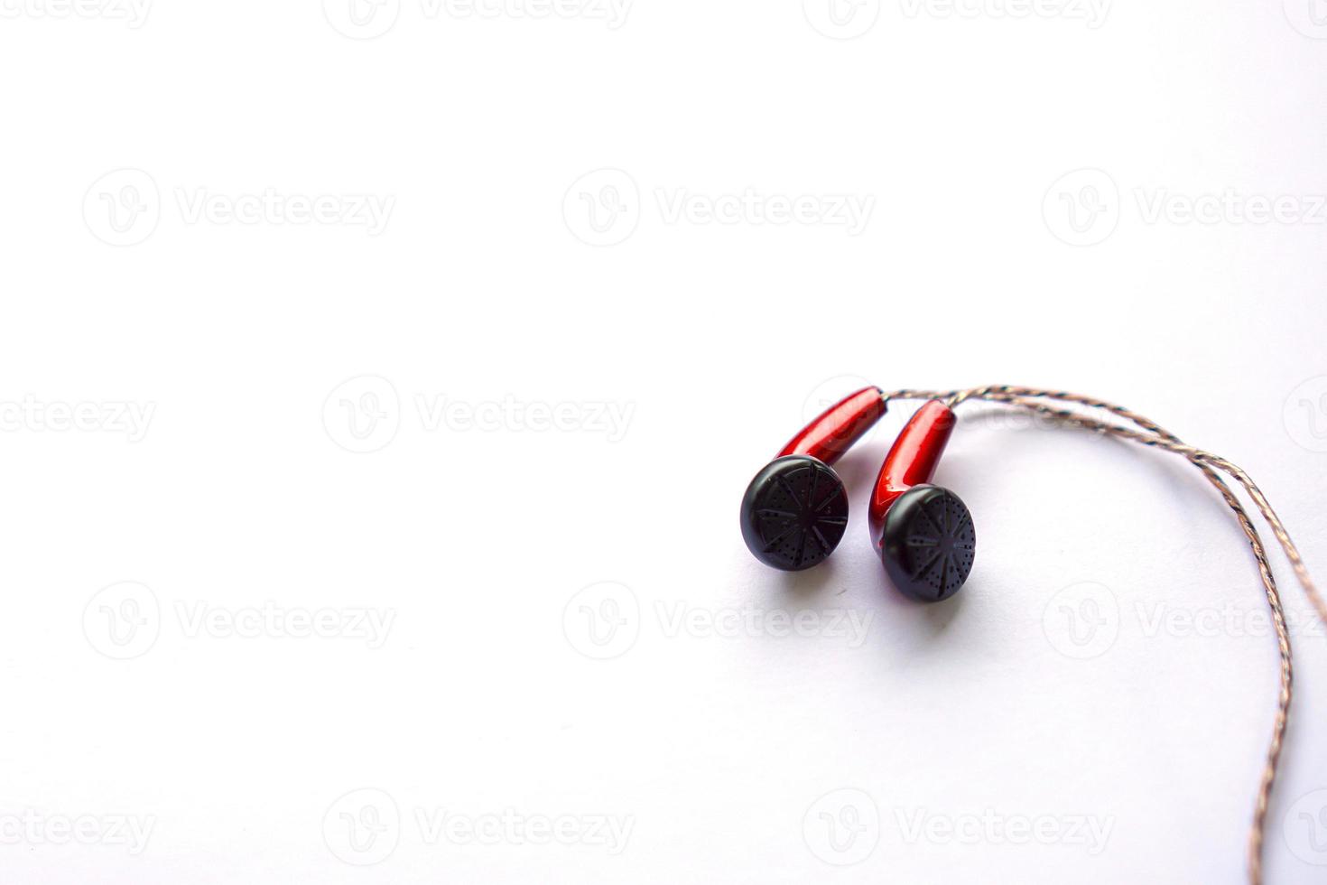 red earphones using wires isolated on white. photo