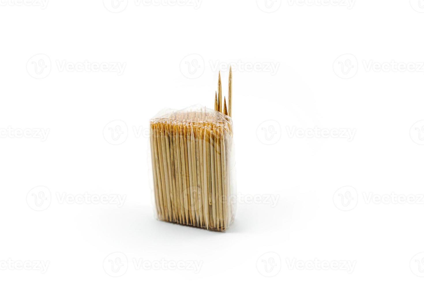 toothpick made of wood wrapped in plastic isolated on a white photo