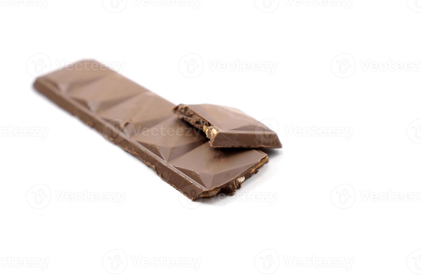 cracked chocolate bar with a composition of chocolate and cashew photo