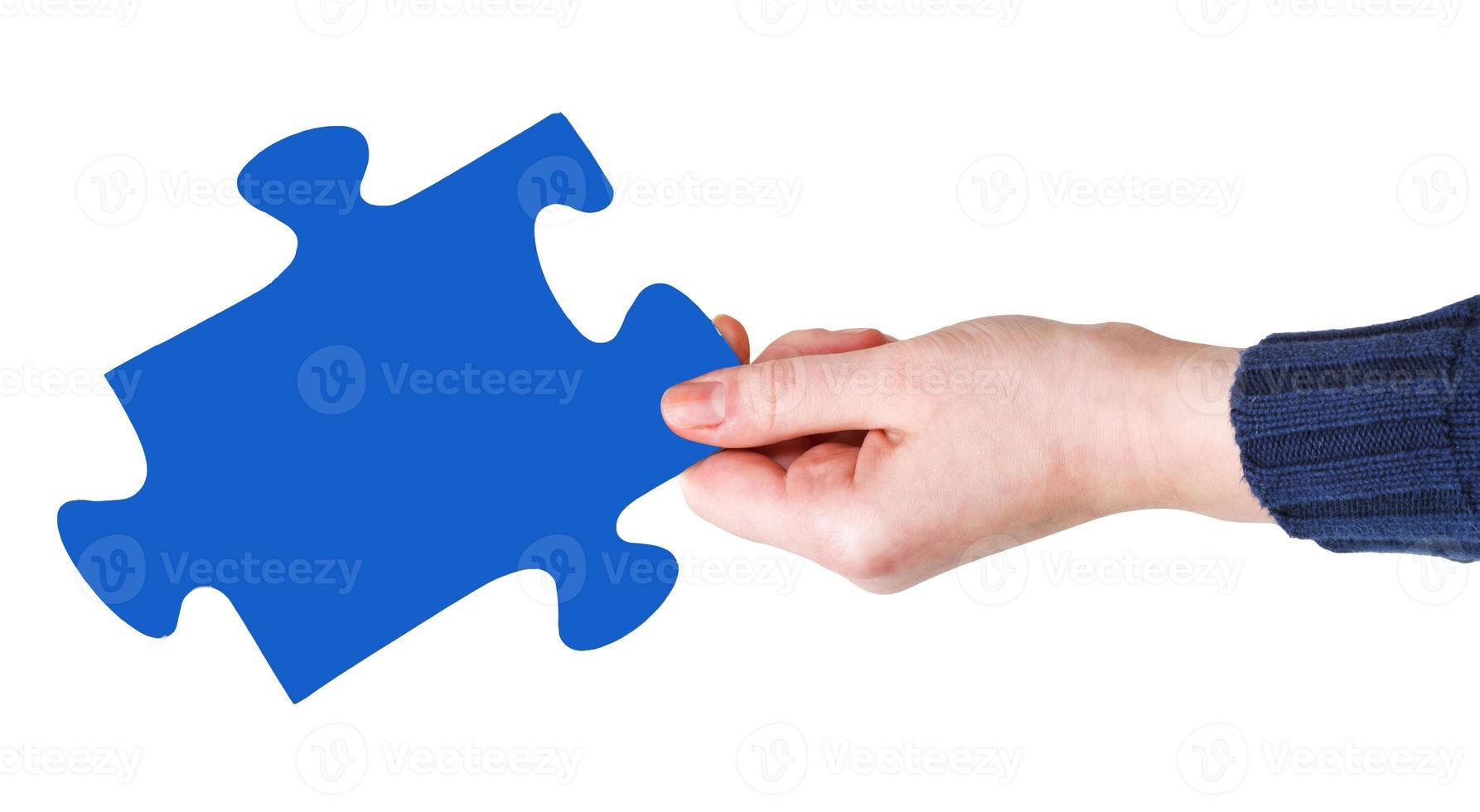 female hand with blue puzzle piece photo