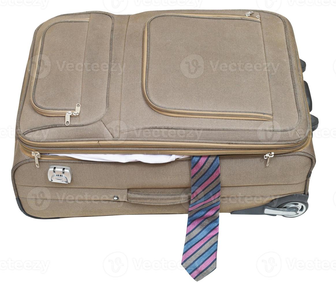 ajar textile suitcase with male tie isolated photo