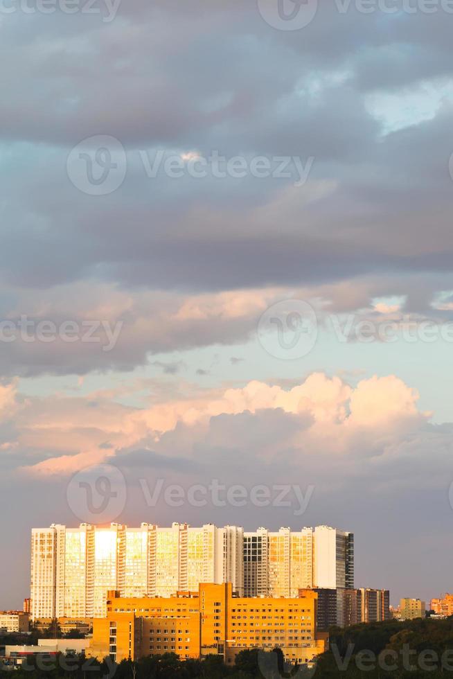 large urban house lit by sunset light in summer photo