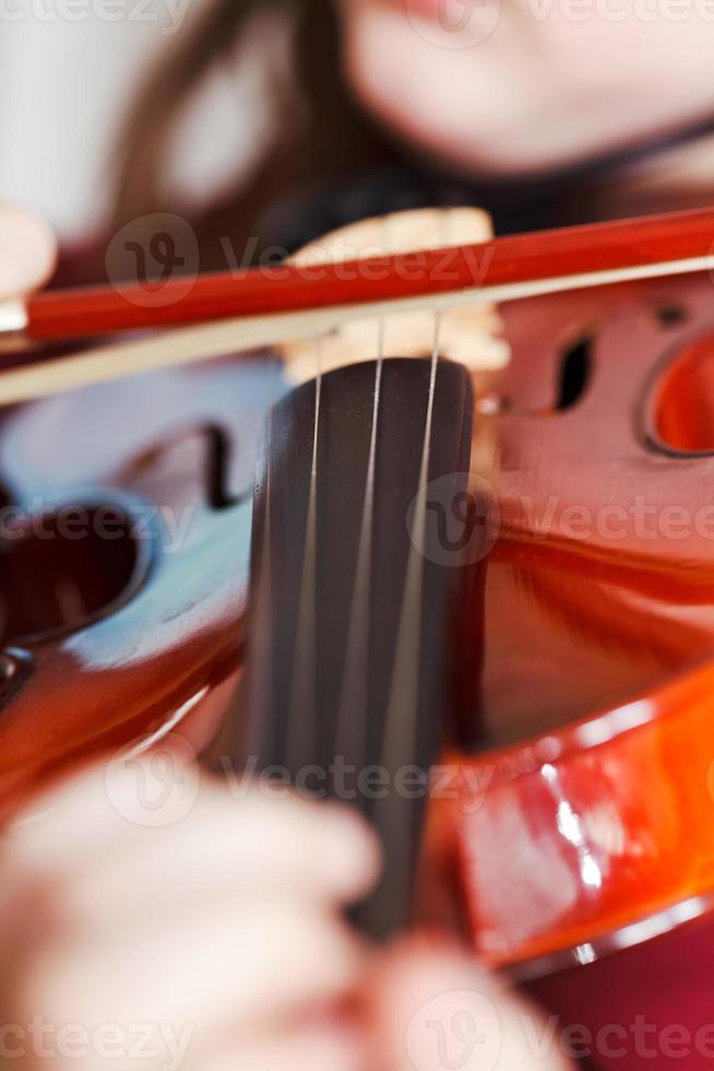 child playing violin by bow photo