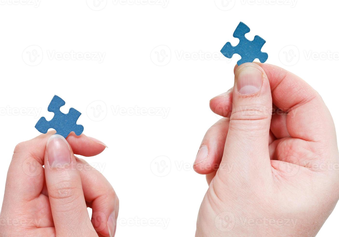 male and female hands with little puzzle pieces photo