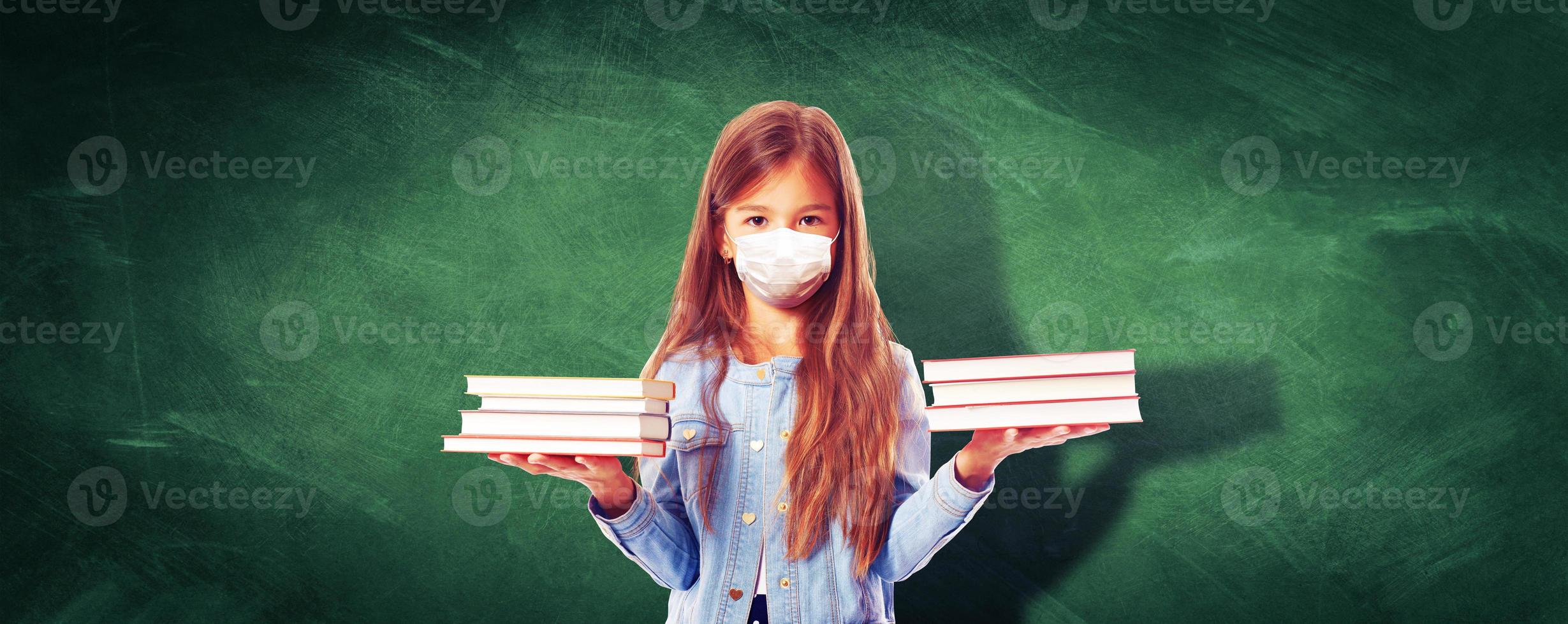 Young girl with protection mask against corona virus at school. photo